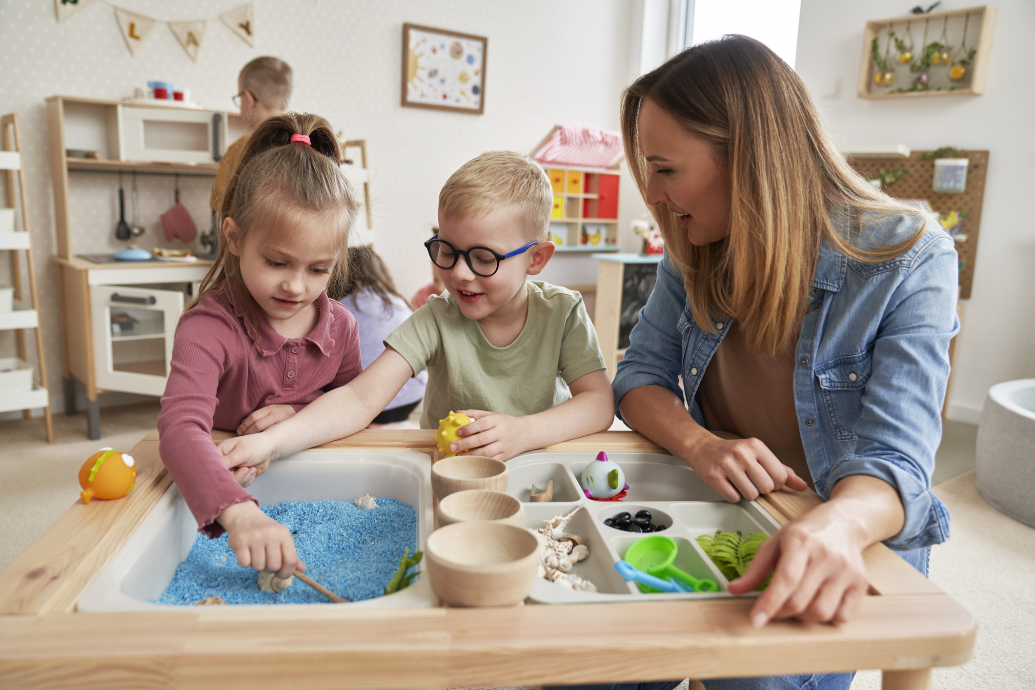 ABA therapist playing with educational and sensory toys during pediatric ABA therapy